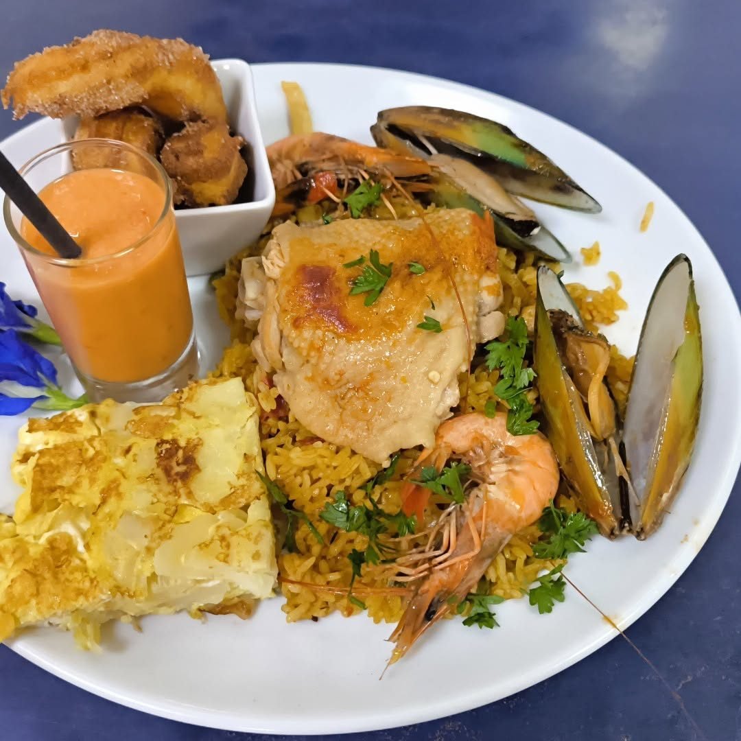 Assiette de riz aux fruits de mer, crevettes, moules et poulet rôti, jus frais